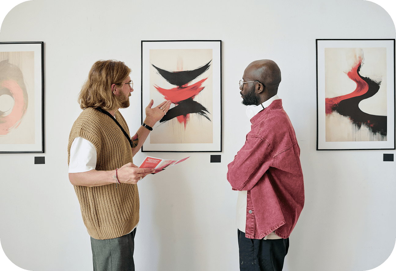 Two men discussing abstract art in gallery.